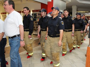 Local men and boys traded in their shoes for a pair of red high heels and walked a mile to help bring awareness and support to the serious issue of violence against women. The third annual Walk a Mile In Her Shoes event, which helped raise $4,000 for Kingston Interval House, was held at the Cataraqui Centre on Saturday. (Julia McKay/The  Whig-Standard)