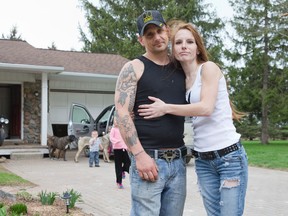 Jared Gilkes and his wife Stefania Goulden stand in the driveway of their home east of London, Ontario, Friday May 9, 2014. (CRAIG GLOVER/QMI Agency)