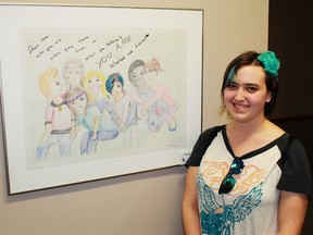 Artist Rebecca Thomas, 16, shows off her work at the St. Clair Child and Youth Services art contest on May 8. Secondary school-aged youth from around Sarnia-Lambton participated in this year's contest, marking Children's Mental Health Week.