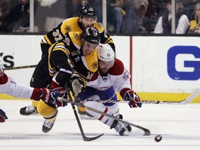 Reilly Smith of the Boston Bruins and David Desharnais of the Montreal Canadiens battle for the puck during the second period of Game 5 at the TD Garden on May 10, 2014.  (Bruce Bennett/Getty Images/AFP)