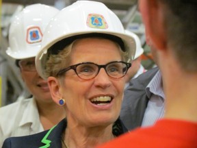 Premier Kathleen Wynne visits the training centre of the Carpenters' District Council of Ontario on May 12, 2014. Wynne criticized PC Leader Tim Hudak's election promise to reduce the public sector payroll by 10%. (ANTONELLA ARTUSO, Toronto Sun)
