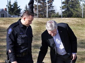 Cst. Matt Williamson and his new dog Ozzie chats with Prime Minister Stephen Harper after a police dog demonstration at the Edmonton Police Service Canine office in Edmonton, Alberta on Monday, May 12, 2014.  Harper was in town to announce Quanto's Law, legislation for greater protection for law enforcement, service, and military animals.  Williamson's dog Quanto was killed while on duty in 2013.  (Perry Mah/ Edmonton Sun)