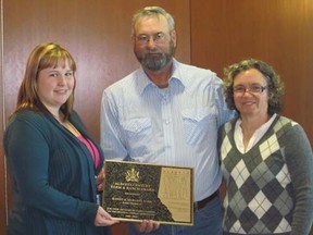 Lisa Rabel (left), agricultural fieldman for Brazeau County, presents Randy and Marlene Robb with the Alberta Century Farm and Ranch Award on behalf of the Brazeau County Agricultural Service Board on April 24. The Alberta Century Farm & Ranch Award salutes those families who have continually owned and actively operated the same land for a minimum of 100 years.