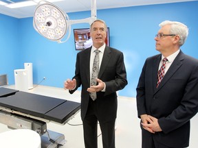 Gerry Price, CEO of the Price Group of Companies (left), gives Premier Greg Selinger a tour of the research and training center at the Price operation in Winnipeg, Man. Monday May 12, 2014. (Brian Donogh/Winnipeg Sun/QMI Agency)