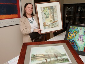April Elliott, Status of Women chair for Elementary Teachers Federation of Ontario — Limestone Local, displays a few of the many pieces of art that will be available at the silent art auction during An Evening with Sally Armstrong, a fundraiser to help support the Sexual Assault Centre Kingston, held at Grant Hall on Tuesday. Julia McKay/The Whig-Standard