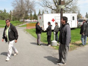 GREG PEERENBOOM/CORNWALL STANDARD-FREEHOLDERKashechewan residents stretch their legs after arriving by bus to their temporary home at the Nav Centre from the Cornwall Regional Airport, where they had been flown in this 2014 file photo.