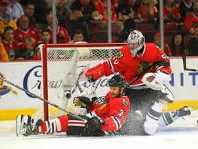 Wild centre Cody McCormick slides into Blackhawks defenceman Brent Seabrook and goaltender Corey Crawford during Game 5 on Sunday night. Chicago can close out the series Tuesday night in Minnesota, where the Wild are undefeated this playoffs. (Dennis Wierzbicki /USA Today Sports)