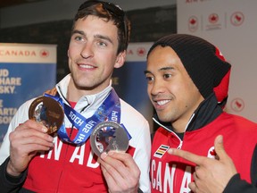 Canadian speed skaters Denny Morrison (left) and Gilmore Junio show off Morrison's medals after returning home from the Winter Olympics. (Jim Wells/QMI Agency)