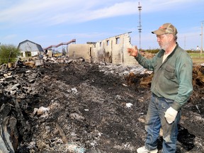 Kingston Park Raceway groundskeeper Ricky Cameron looks over a barn on Monday after a fire in north-end Kingston on Sunday killed four horses. Eight horses were rescued. IAN MACALPINE /THE WHIG-STANDARD