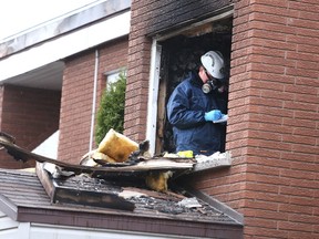 Gino Donato/The Sudbury Star
Ontario Fire Marshal investigator James Allen takes notes as he investigates a fire on Rita Street in Hanmer on Monday evening. Two people were seriously injured when a fire broke out around 3:30 in the afternoon.
