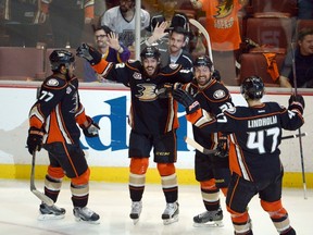 Ducks right wing Devante Smith-Pelly (77) celebrates with centre Mathieu Perreault (22), defenceman Francois Beauchemin (23)  and defenceman Hampus Lindholm (47) after scoring a goal against the Kings in Game 5 playoff action in Anaheim on Monday, May 12, 2014. (Kirby Lee/USA TODAY Sports)