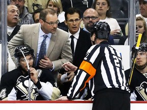 Pittsburgh Penguins head coach Dan Bylsma talks to referee Eric Furlatt against the New York Rangers during Game 2 of their Eastern Conference semifinal series at the Consol Energy Center in Pittsburgh, May 4, 2014. (CHARLES LeCLAIRE/USA Today)