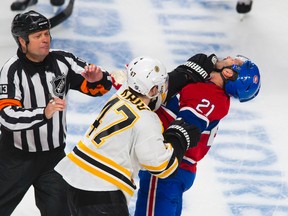 Torey Krug strikes Brian Gionta in the third period of Game 6 between the Montreal Canadiens and Boston Bruins at the Bell Centre on May 12, 2014. (QMI Agency)
