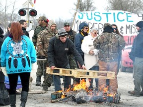 First Nation's bands form a blockade at the main VIA rail line between Toronto and Ottawa near Marysville, Ontario March 19, 2014. The blockade was part of a day of action to call attention to missing and murdered indigenous and aboriginal women.  (REUTERS/Fred Thornhill)