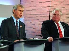 Rob Ford listens to David Soknacki during the first TV debate of the mayoral campaign in Toronto March 26, 2014. (Dave Abel/Toronto Sun)