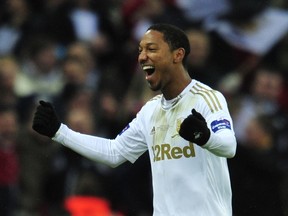 Swansea City's Canadian-born Dutch midfielder Jonathan de Guzman celebrates scoring their fourth goal from the penalty spot during the League Cup final football match between Bradford City and Swansea City at Wembley Stadium in London, England on February 24, 2013. (AFP)