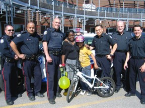 Toronto Police officers from 23 Division have given an 11-year-old disabled boy a replacement bike after his bicycle was stolen over the weekend in Rexdale. (PHOTO COURTESY OF TORONTO POLICE)