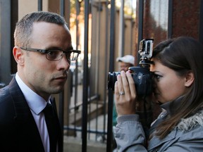 Oscar Pistorius (left) arrives ahead of his trial for the murder of his girlfriend Reeva Steenkamp in Pretoria on Tuesday, May 13, 2014. (Siphiwe Sibeko/Reuters)