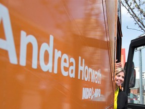 Ontario NDP leader Andrea Horwath waves to supporters as she gets back onto her bus following a tour of the Covent Garden Market in London, Ontario on Thursday May 8, 2014. (CRAIG GLOVER, The London Free Press)