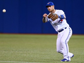 Brett Lawrie of the Toronto Blue Jays throws to first against the Cleveland Indians during MLB action in Toronto, Ont. on Tuesday May 13, 2014. (Dave Abel/Toronto Sun/QMI Agency)