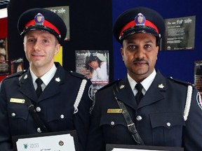 Consts. Musial Bartosz, left, and Trevor Joseph with their Toronto Police Services Officers of the Month Award on Tuesday, May 13, 2014. (Dave Thomas/Toronto Sun)