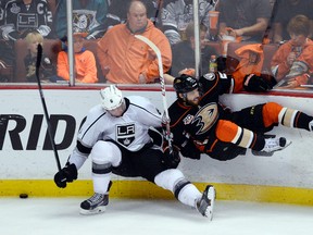 Los Angeles Kings defenceman Jake Muzzin (left) collides with Anaheim Ducks centre Mathieu Perreault. (Richard Mackson/USA TODAY Sports)