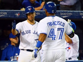Kevin Pillar (left) and Juan Francisco of the Toronto Blue Jays celebrate Francisco's home run against the Cleveland Indians during MLB action in Toronto, Ont. on May 13, 2014. (DAVE ABEL/Toronto Sun)