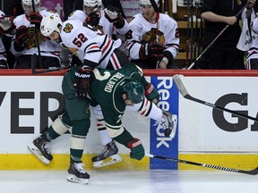 Minnesota Wild defenceman Keith Ballard (front) was put out of commission by Chicago Blackhawks forward Brandon Bollig during 
Game 4 of their series. (Brace Hemmelgarn /USA Today Sports)