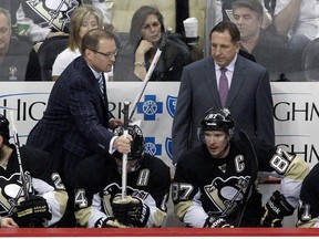 Penguins head coach Dan Bylsma hands a new stick to left wing Chris Kunitz during Game 7 against the New York Rangers on Tuesday night. (Charles LeClaire/USA TODAY Sports)