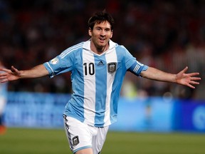 Argentina's Lionel Messi celebrates after he scored his team's first goal against Chile during the 2014 World Cup qualifying soccer match in Santiago, in this October 16, 2012 file photo. (REUTERS)
