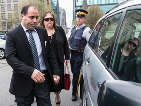 Mohamed Harkat exits the Supreme Court of Canada through a side door with his wife Sophie after the Court declared the federal government's security certificate regime constitutional. May 14, 2014. Errol McGihon/Ottawa Sun/QMI Agency