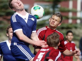 Cochrane High Ross Mills, right, and Bow Valley High’s Michael White go high in the air to head the ball as Cobras Jacob Kitzul (5) looks on during a 3-1 victory for CHS in a close match on May 8.