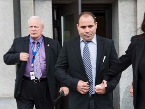 Mohamed Harkat exits the Supreme Court of Canada through a side door with his wife Sophie after the Court declared the federal government's security certificate regime constitutional. May 14, 2014. Errol McGihon/QMI Agency