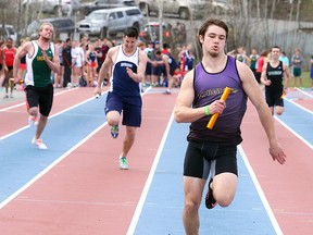 Lo Ellen's Dalton Milford gets set to cross the line to win the senior boys 4x100 relay on Wednesday afternoon.