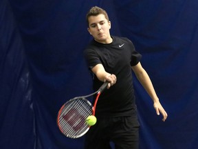 Phillipe Butler, of College Notre Dame, returns the ball during a match at the boys doubles high school tennis championships at the Sudbury Indoor Tennis Centre on Wednesday, May 14, 2014.