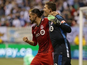 Toronto FC's Issey Nakajima-Farran (left) and goalkeeper Joe Bendik celebrate their shootout win over the Vancouver Whitecaps FC during the Amway Canadian Championship semifinal game at BC Place in Vancouver, B.C. on Wednesday May 14, 2014. (Carmine Marinelli/Vancouver 24hours/QMI Agency)