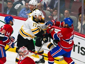 Boston Bruins winger Milan Lucic battles with Montreal Canadiens forward Dale Weise during Game 7 of the NHL Eastern Conference semifinals at the Bell Centre in Montreal, May 12, 2014. (BEN PELOSSE/QMI Agency)