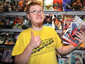 London Comic Con organizer Jake Windatt poses with a couple comics at Heroes in London, Ont. May 13, 2014. London Comic Con, a celebration of comics, TV, movies and various pop culture, takes place at Centennial Hall June 14-15. CHRIS MONTANINI\LONDONER\QMI AGENCY