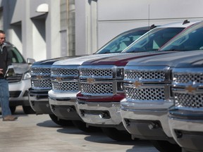 A man walks past a row of General Motors vehicles at a Chevrolet dealership on Woodward Avenue in Detroit, Michigan April 1, 2014. (REUTERS/Rebecca Cook)