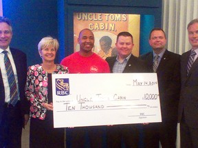 Uncle Tom's Cabin Historical Site's Steven Cook, centre, receives a $10,000 donation from RBC Foundation's, from left to right, Terry Neuber, Francine Dyksterhuis, Travis Hooper, Michael Caverly and Stephen Mattis. The donation will help with Uncle Tom's Emancipation Day celebrations planned for August.