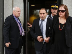 Algerian citizen Mohamed Harkat (2nd L) and his wife Sophie (R) leave the Supreme Court of Canada in Ottawa May 14, 2014.   REUTERS/Chris Wattie