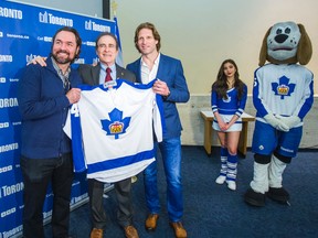 Deputy Mayor Norm Kelly, centre, is flanked by Maple Leafs alumni Darcy Tucker, left, and Shayne Corson. (ERNEST DOROSZUK/Toronto Sun)