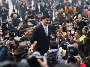 Former NBA basketball player Yao Ming (C), who is a delegate of the Chinese People's Political Consultative Conference (CPPCC), is surrounded by media ahead of the opening of CPPCC outside the Great Hall of the People in Beijing, March 3, 2014. (REUTERS)