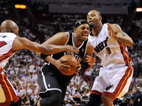 Nets forward Paul Pierce (centre) drives to the basket as Miami Heat guard Ray Allen (left) and Miami Heat forward Rashard Lewis defend during Game 5 of their second-round playoff series at American Airlines Arena on Wednesday night. (REUTERS)