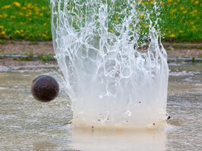 It was that kind of a day at the first day of the TVRA track and field meet as a shot put splashes during the midget boys shot put (MIKE HENSEN, The London Free Press)