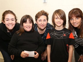 JOHN LAPPA/THE SUDBURY STAR/QMI AGENCY 
Adriana Roque, left, her mother, Fran, Tannys Laughren, executive director of the Northern Cancer Foundation, and Northeastern Elementary School students Grace Caberley, second left, and Owen Pawluk show their smiles at the launch of the Smile Project at the Garson school on Wednesday, May 14, 2014. The project consists of Northeastern students creating art, jokes and poems that make the students smile. The items will be delivered before the end of the school year to the foundation for distribution to cancer patients, with the hope that the creations will bring a smile, courage and strength to patients fighting cancer. The idea for the project came from teacher Cristina Roque (sister and daughter of Adriana and Fran) who lost her battle with cancer on March 5, 2012 at the age of 29.