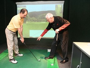 Rene Grandmaison, certified golf instructor shows Yvon Landry how to attain a perfect swing.
Gino Donato/The Sudbury Star