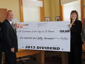 Board chairman Jim Herbert, left,  and Ascent CEO Ron Osborne present a $250,000 dividend cheque for 2013 to Mayor Heather Jackson and CAO Wendell Graves.