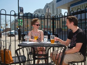 Margaret Cormier, 24 and Keelan Harkin, 25 enjoy a craft beer on the patio of Milo's Craft Beer Emporium in London. (File photo)