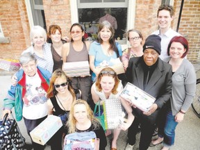 About 150 shoeboxes filled with treats and everyday items were handed out to women at My Sisters? Place on May 9 for Mother?s Day. The Shoebox Project collected donations from Londoners in hopes of handing out about 700 boxes to clients at several city agencies. Celebrating the donation were, front row, from left, Nina, Brandy, Amber, Jennifer, Lisa and Shoebox co-ordinator Norma Sharpe, and back row, from left, My Sisters? Place director Susan Macphail, Sonya, Carol, Allie, Cathy and Shoebox co-ordinator David Brebner. (For reasons of privacy, My Sisters? Place clients generally provide first names only.) (Randy Richmond/London Free Press)